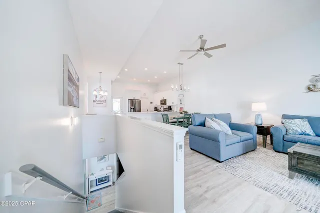 a living room with furniture and a ceiling fan