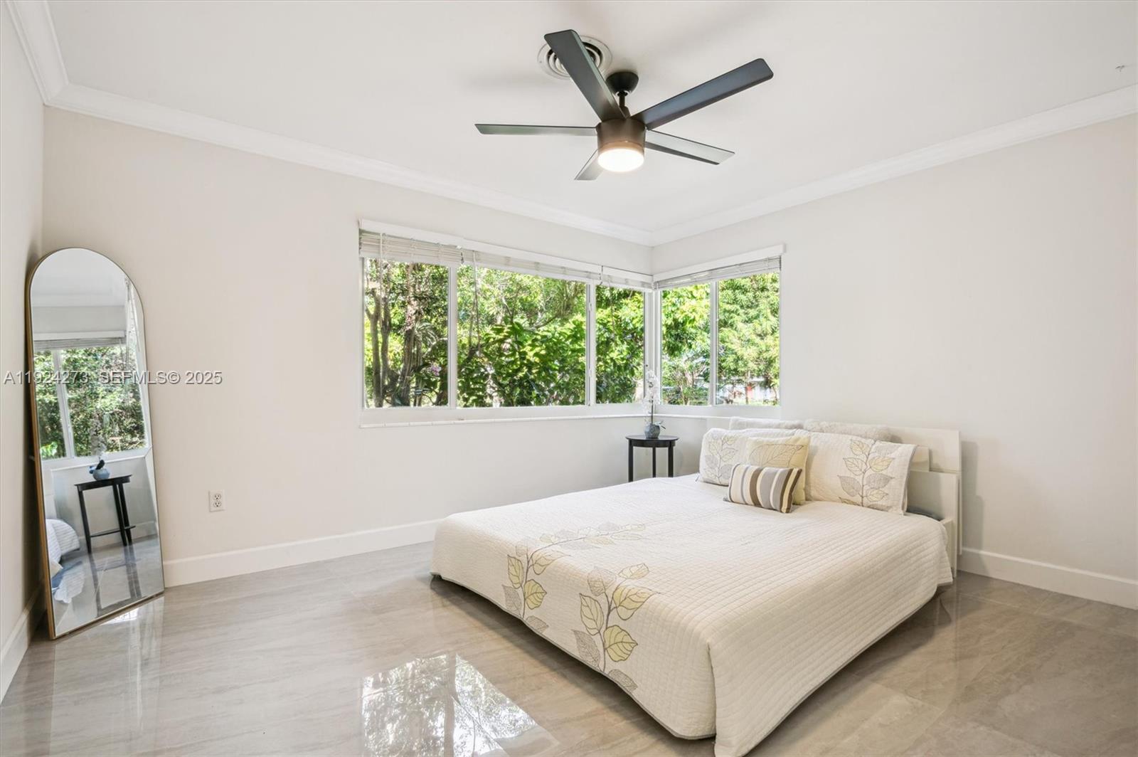 4316 Southwest 6th Street Plantation, FL 33317 - Photo 12 of 24 a bedroom with a large bed and a large window