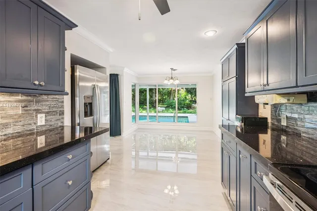 a open kitchen with granite countertop a stove a sink and dishwasher wooden cabinets with granite countertops