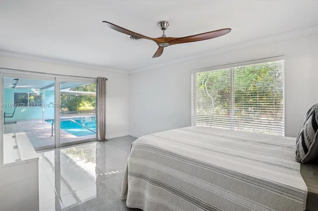a bedroom with a bed and glass door