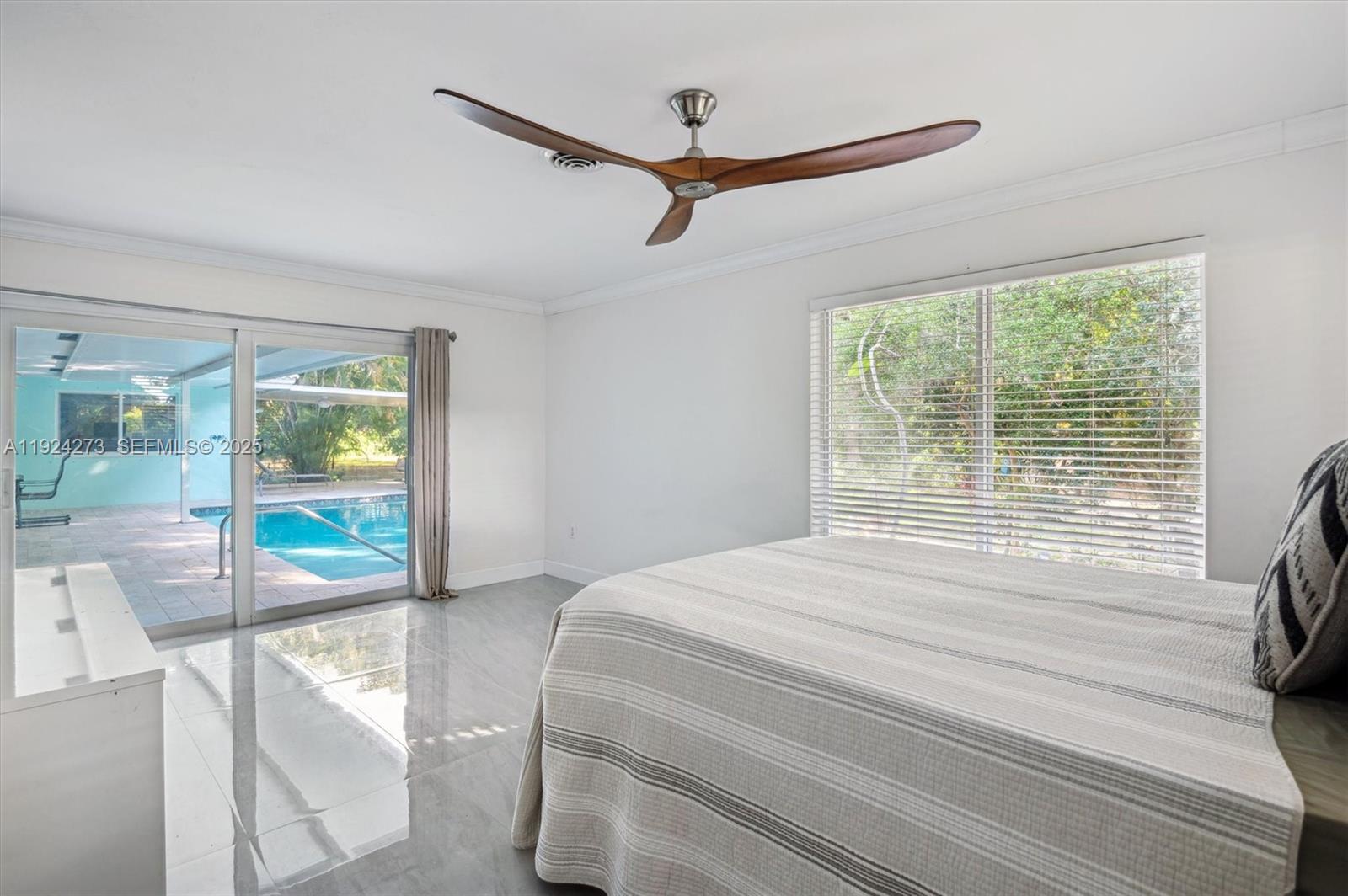 4316 Southwest 6th Street Plantation, FL 33317 - Photo 3 of 24 a bedroom with a bed and glass door