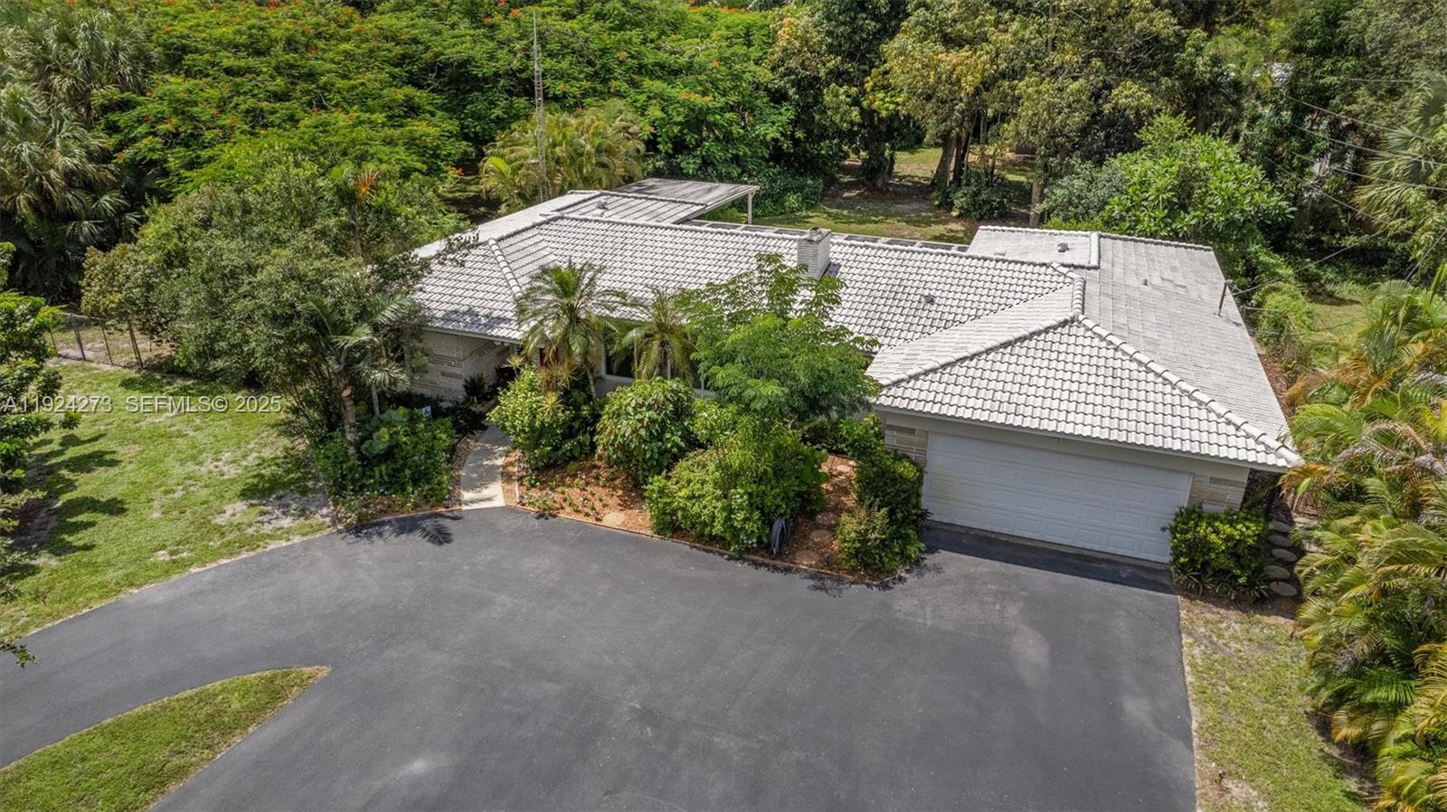 4316 Southwest 6th Street Plantation, FL 33317 - Photo 5 of 24 a view of a house with a yard and garage