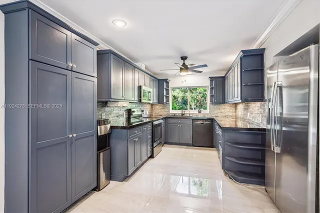 a view of a room with a large window and kitchen view