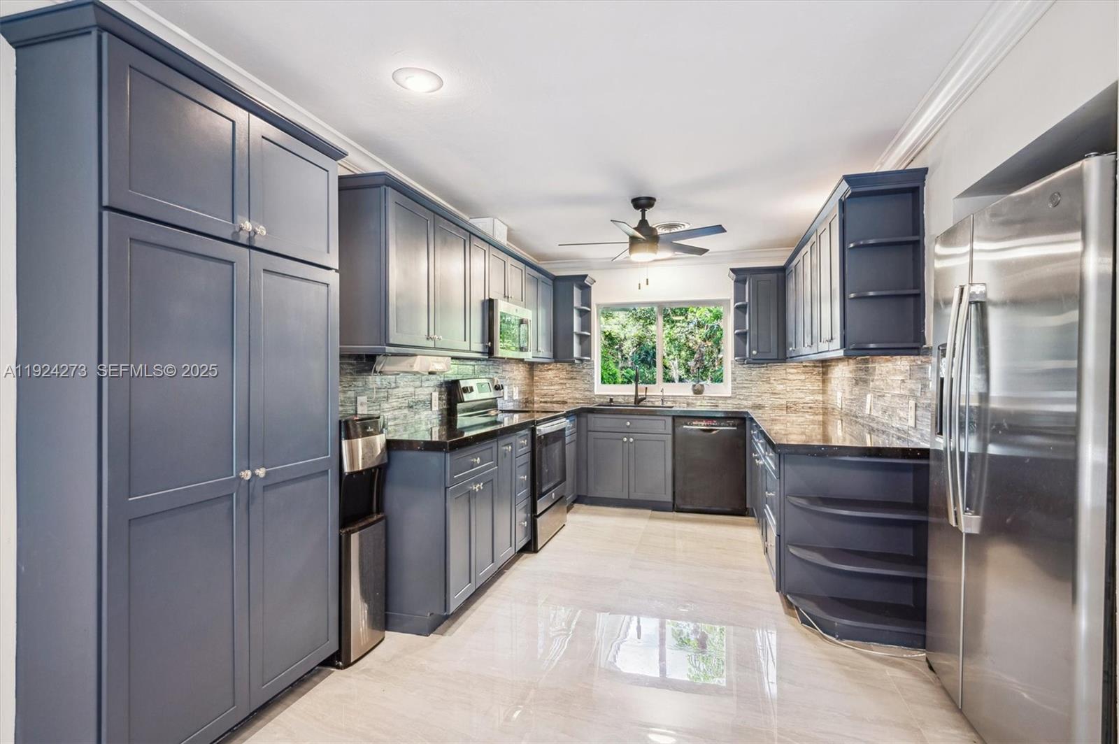 4316 Southwest 6th Street Plantation, FL 33317 - Photo 8 of 24 a kitchen with a refrigerator and cabinets