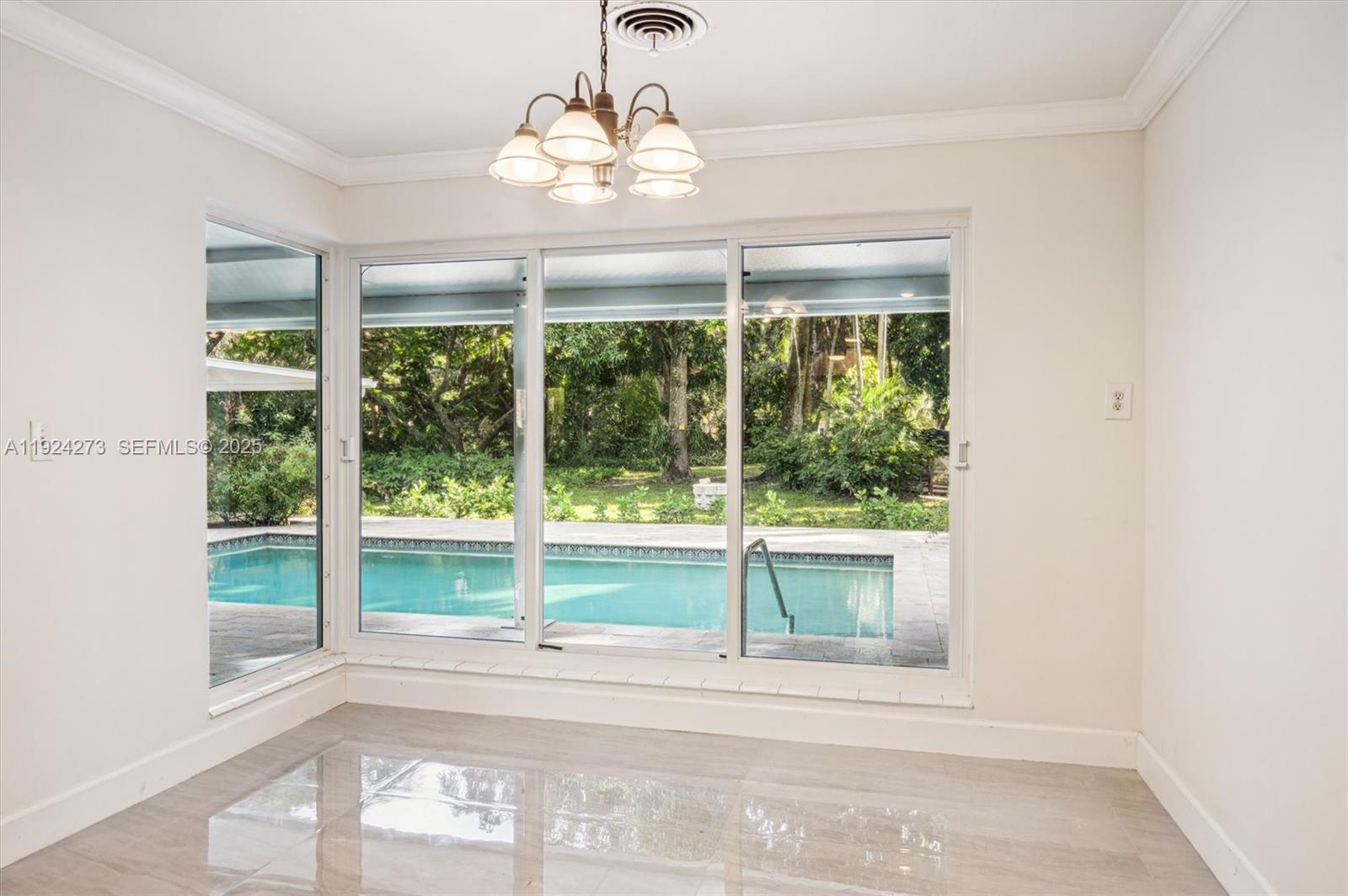 4316 Southwest 6th Street Plantation, FL 33317 - Photo 9 of 24 a view of a room with a large window and kitchen view