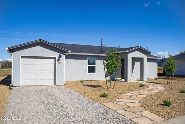 a view of house with backyard and parking space