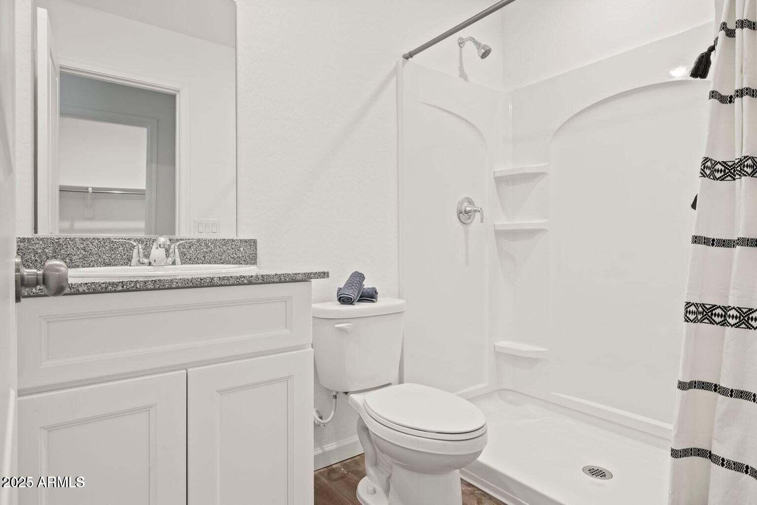20050 East Lakeside Road Mayer, AZ 86333 - Photo 18 of 22 a bathroom with a sink toilet vanity and shower