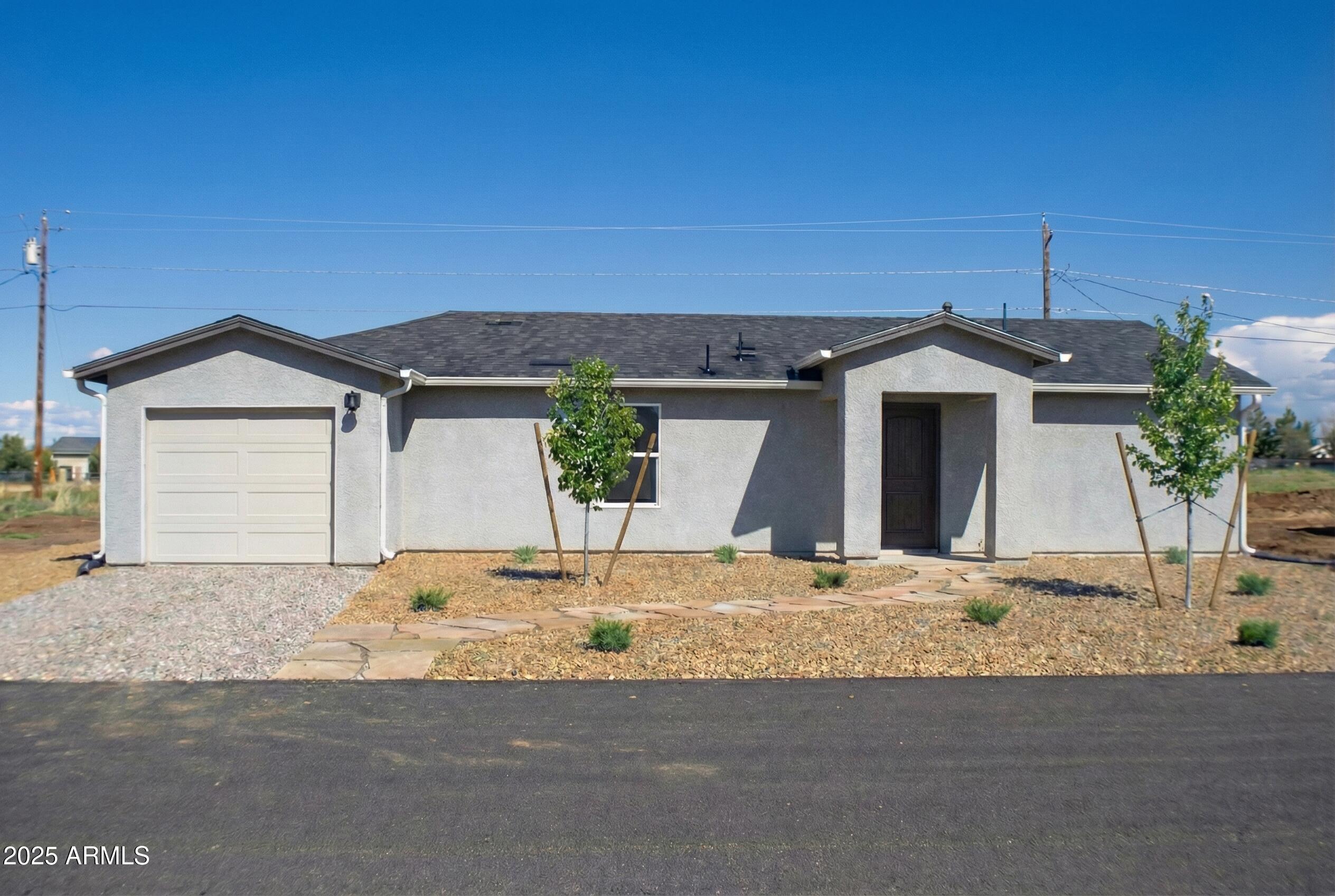 20050 East Lakeside Road Mayer, AZ 86333 - Photo 2 of 22 a front view of a house with a yard