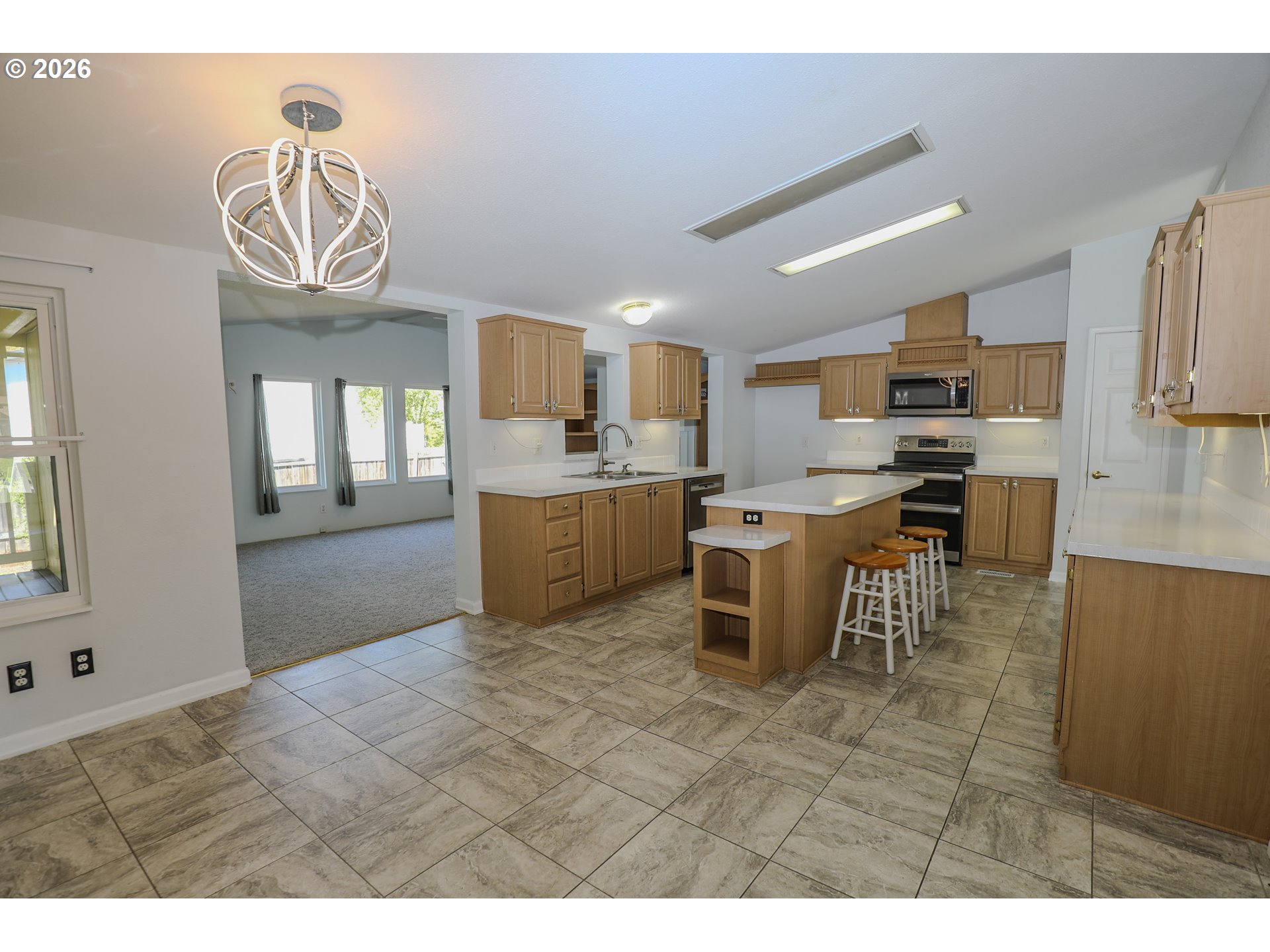 210 Northwest Timothy Avenue Winston, OR 97496 - Photo 17 of 48 a kitchen with kitchen island granite countertop a sink counter top space appliances and cabinets