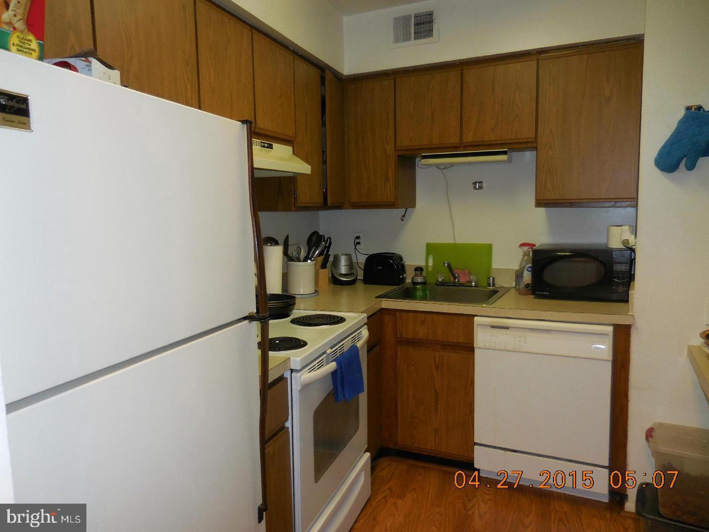 5808 Royal Ridge Drive, Unit L Springfield, VA 22152 - Photo 3 of 15 a kitchen with a sink a stove and cabinets