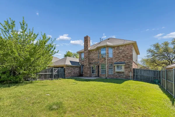 a view of a garden with a building in the background