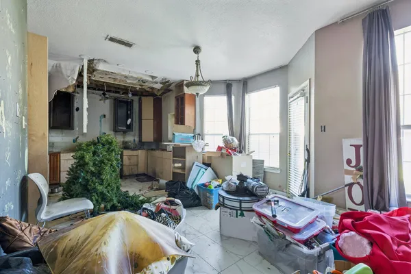 a living room with patio furniture and a chandelier