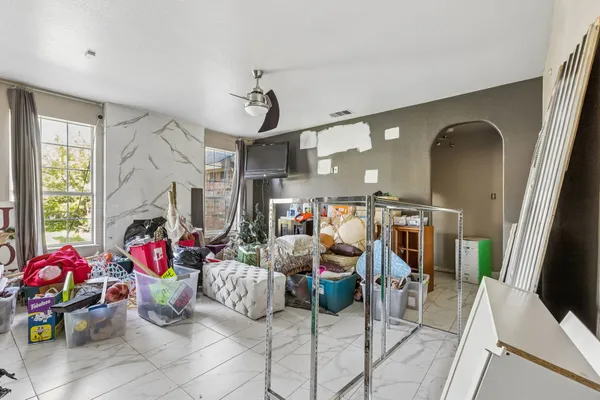 a living room with lots of furniture and a chandelier