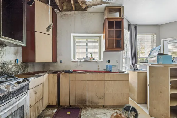 a kitchen with a sink cabinets and window