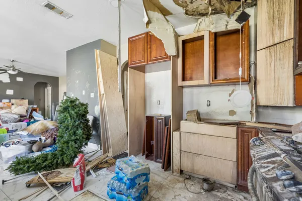 a kitchen with a sink stove and cabinets