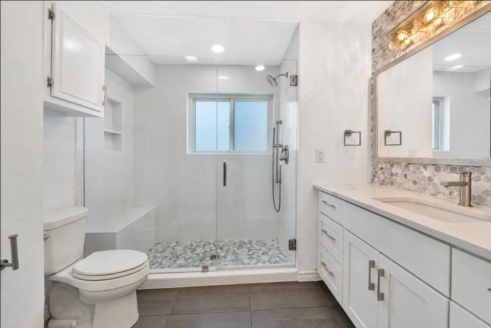 2909 Normandy Court Euless, TX 76039 - Photo 28 of 36 a bathroom with a granite countertop sink toilet and shower