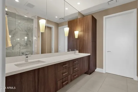 a bathroom with a double vanity sink and a mirror