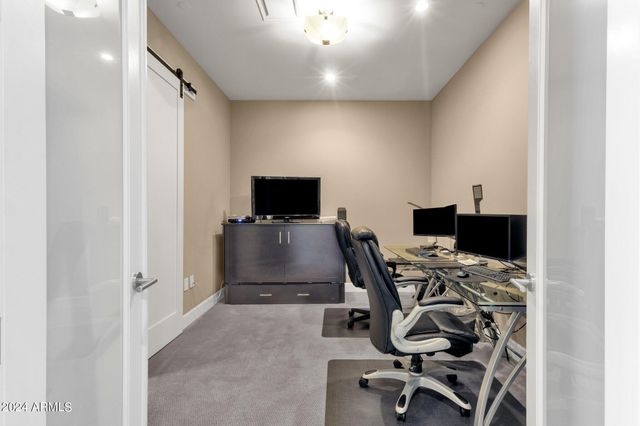 a view of a workspace with furniture and tv