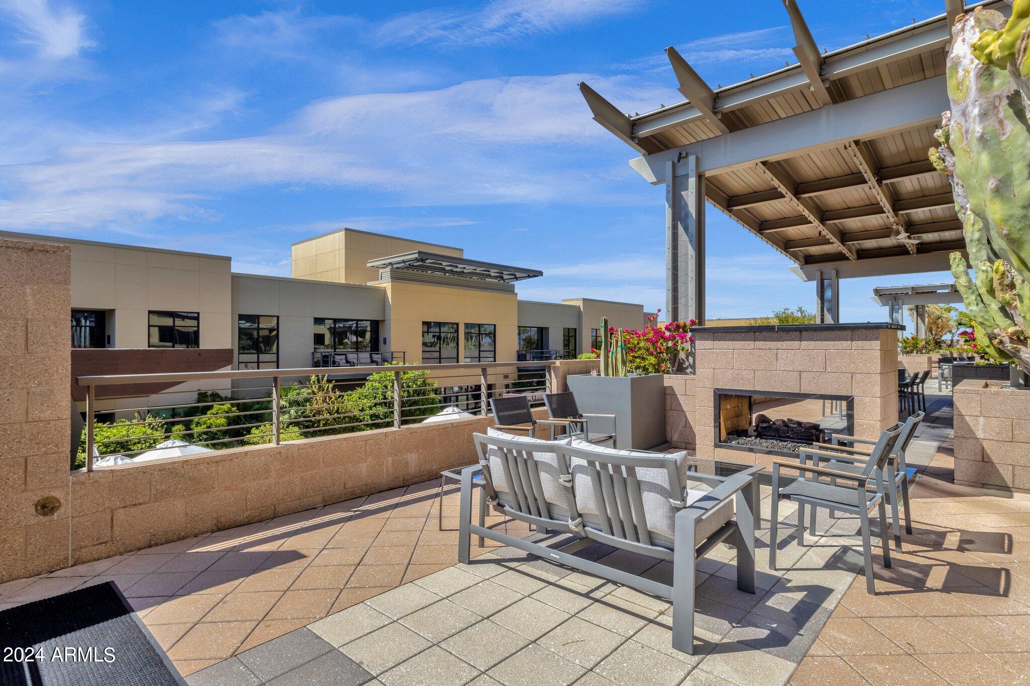 15215 North Kierland Boulevard, Unit 436 Scottsdale, AZ 85254 - Photo 40 of 44 a view of a patio with couches table and chairs with potted plants