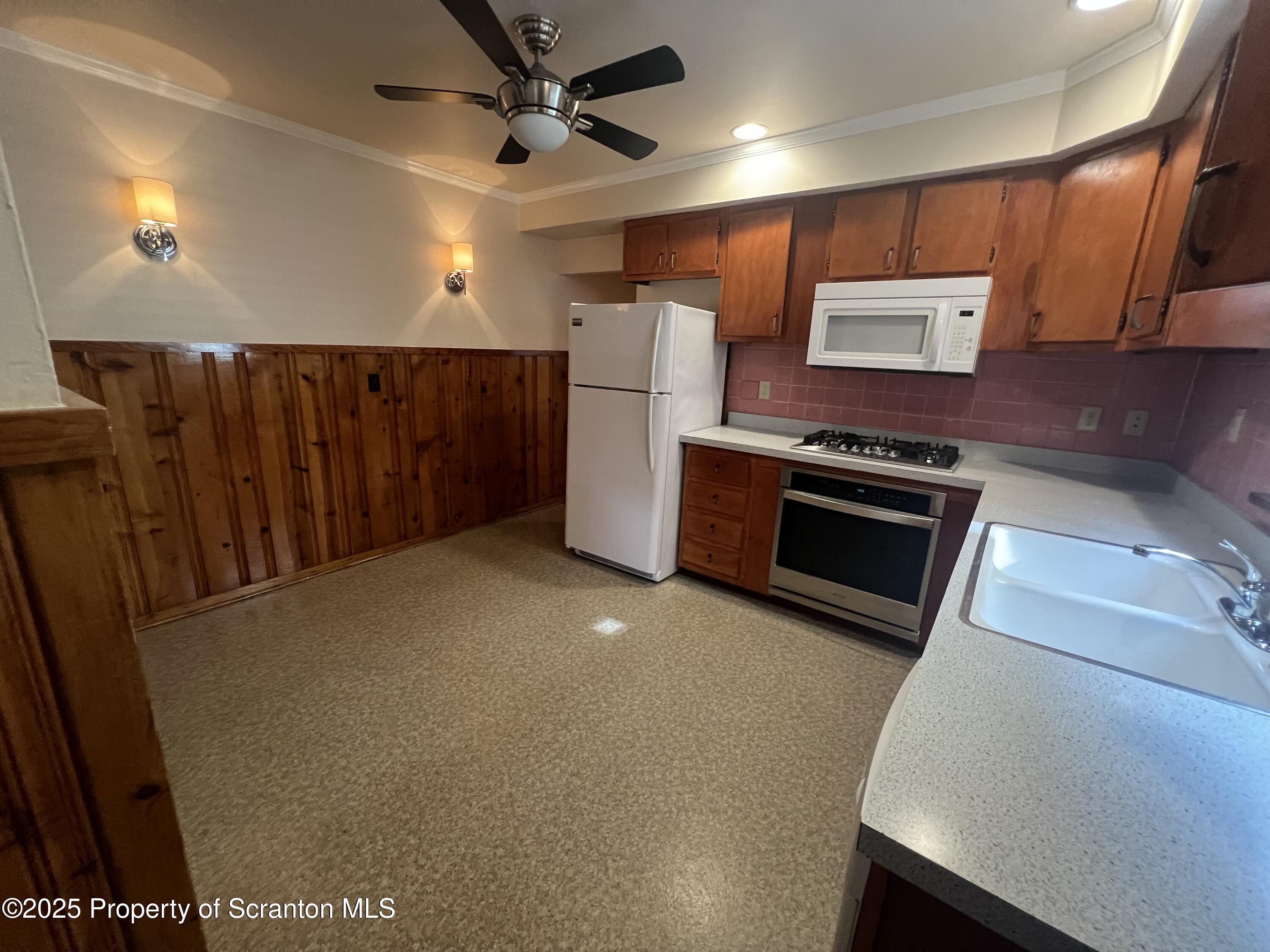 956 Meade Avenue, Unit 1 Scranton, PA 18508 - Photo 4 of 11 a view of a kitchen with a fridge
