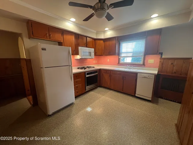 a kitchen with sink a refrigerator and cabinets
