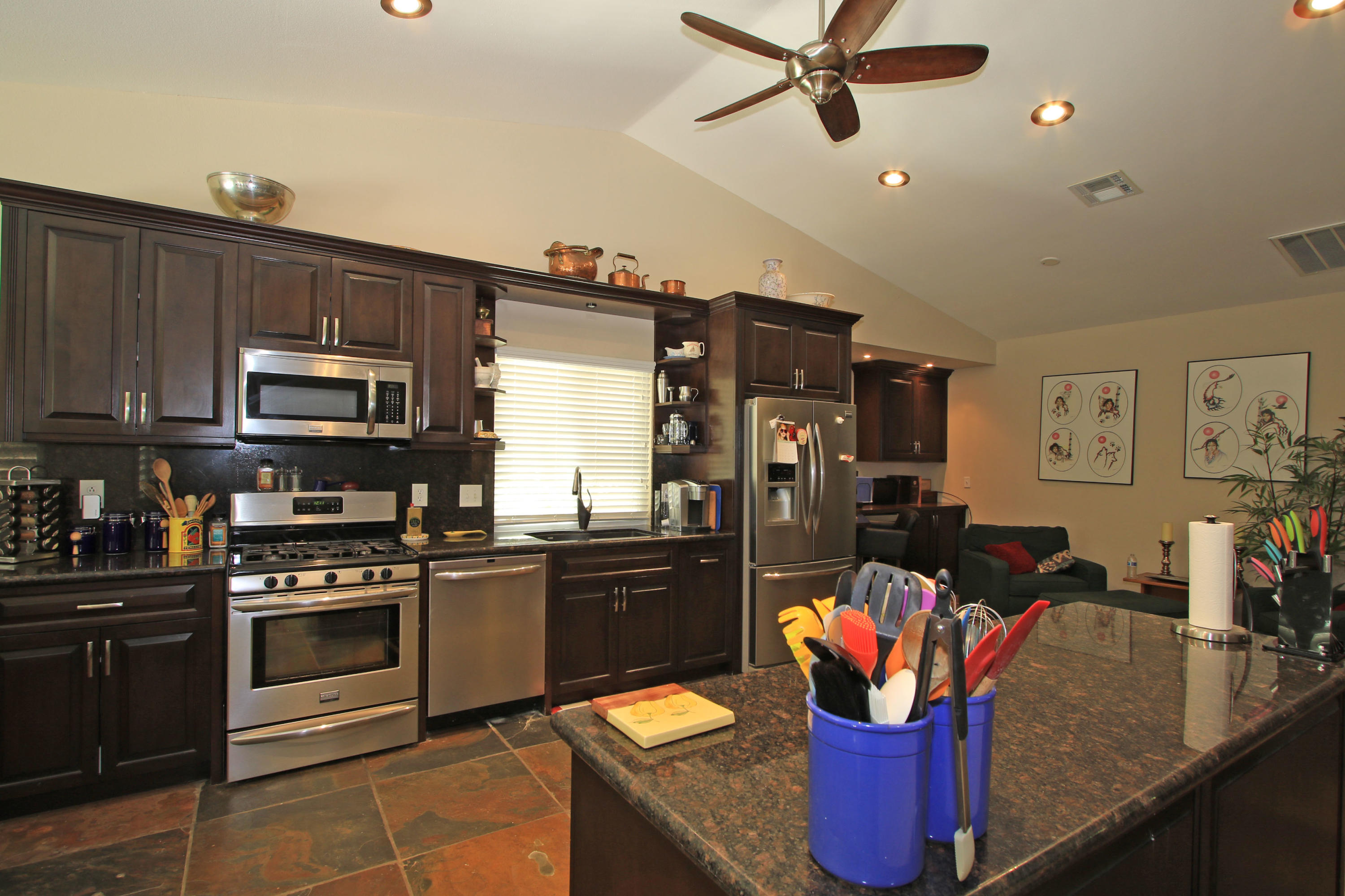 39730 Regency Way Palm Desert, CA 92211 - Photo 19 of 35 a kitchen with stainless steel appliances granite countertop a stove refrigerator and microwave