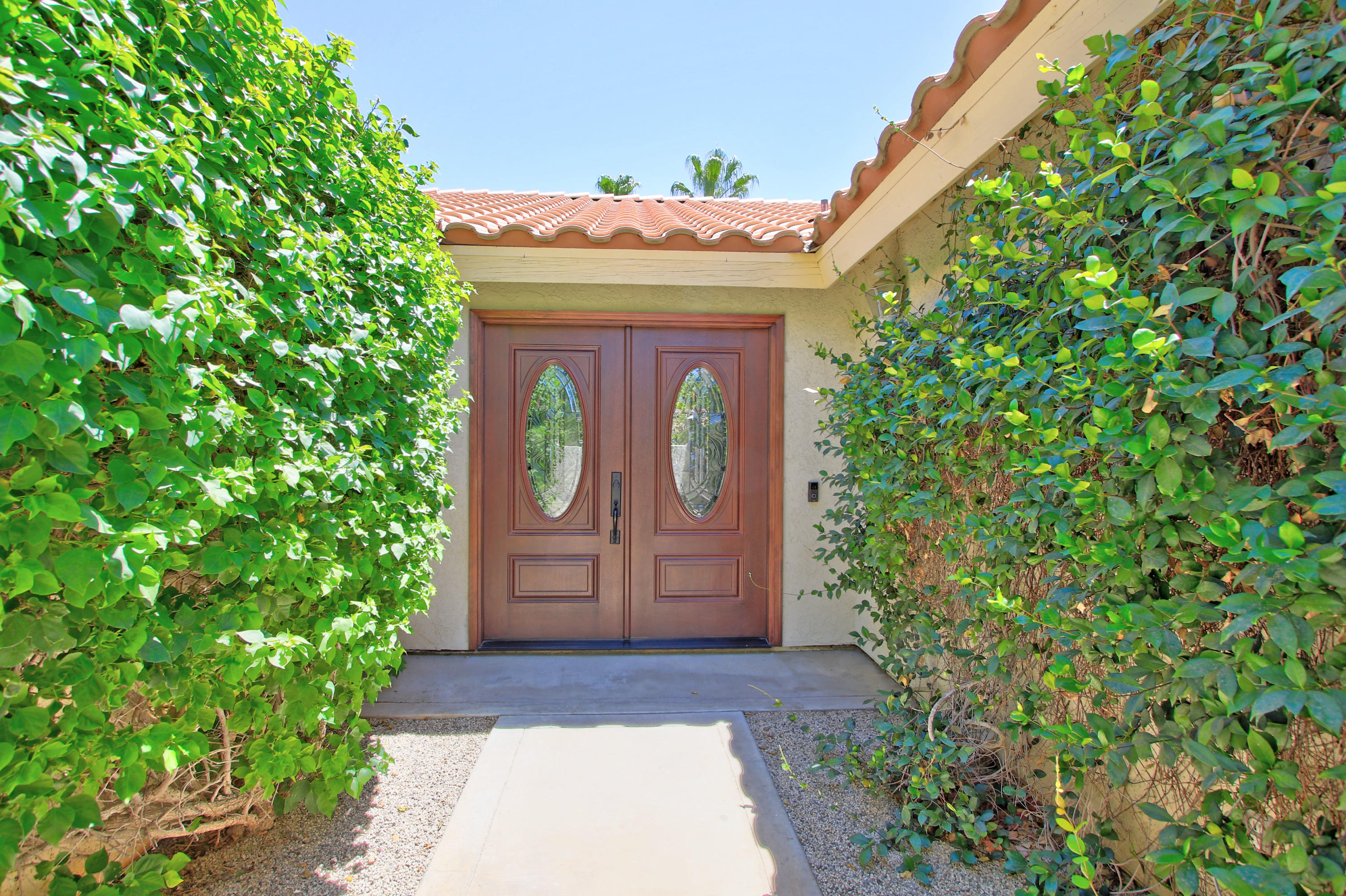 39730 Regency Way Palm Desert, CA 92211 - Photo 3 of 35 a front view of a house with a garden