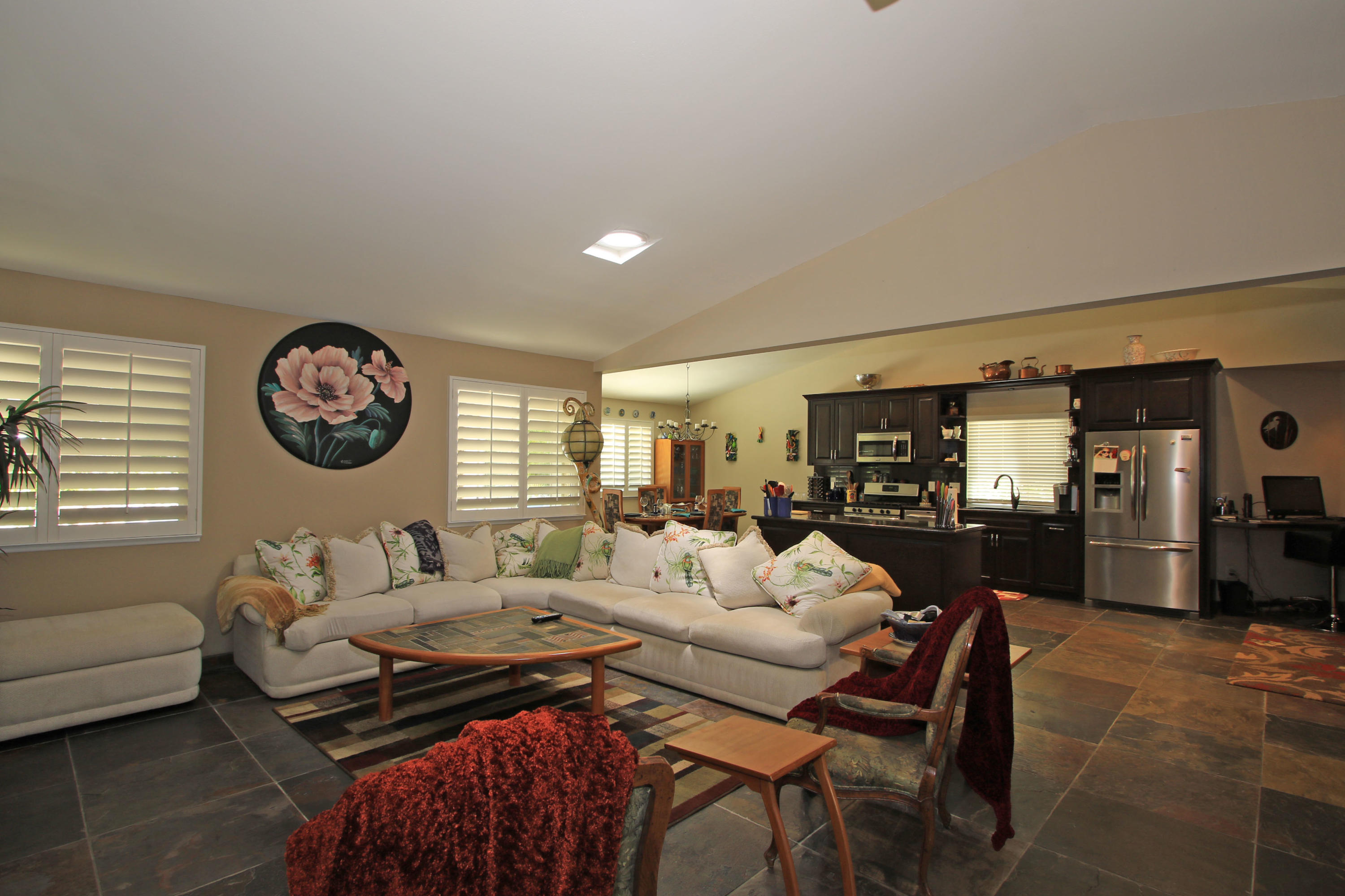 39730 Regency Way Palm Desert, CA 92211 - Photo 23 of 35 a living room with furniture a clock on wall and a window