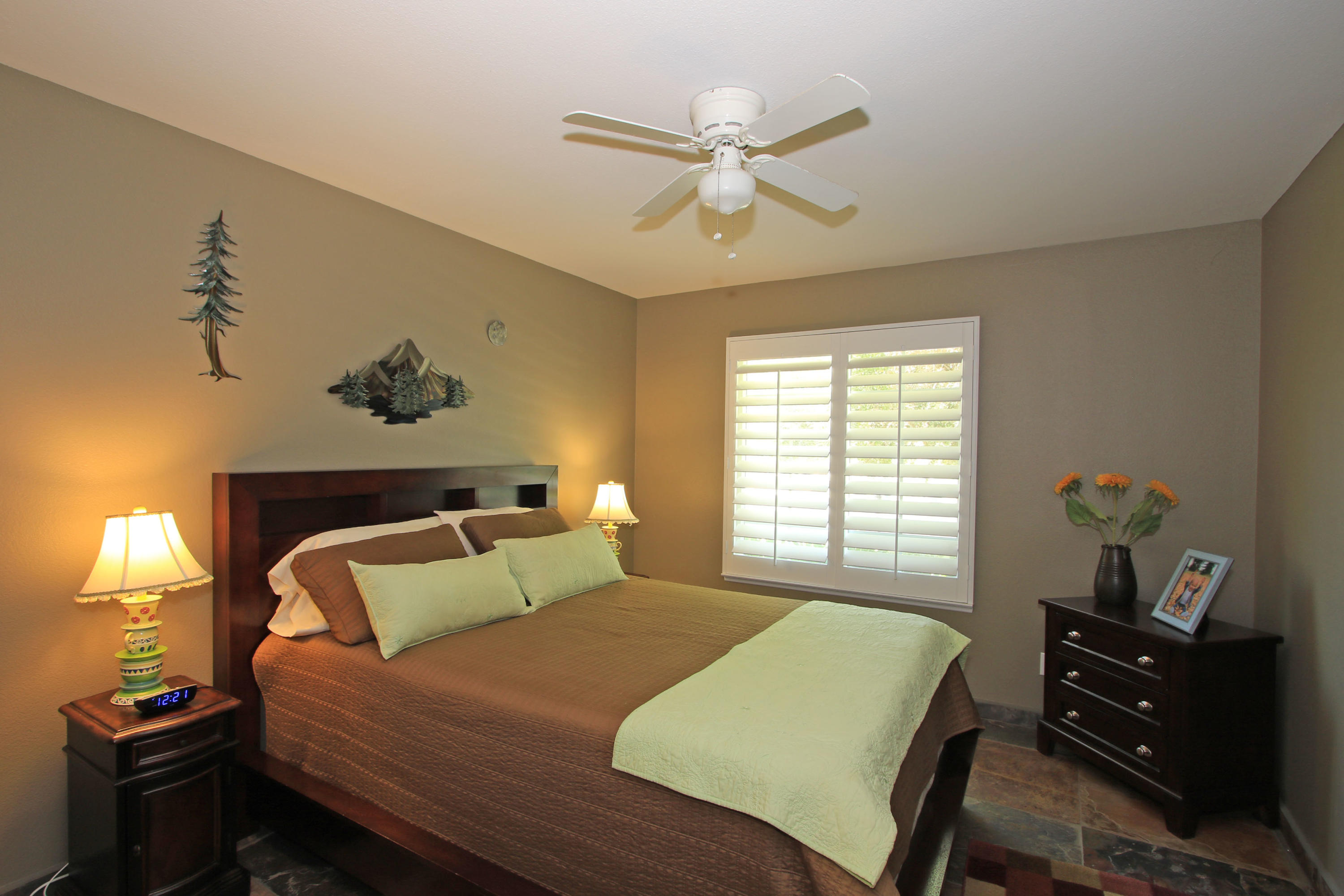 39730 Regency Way Palm Desert, CA 92211 - Photo 29 of 35 a bedroom with a bed and a chandelier