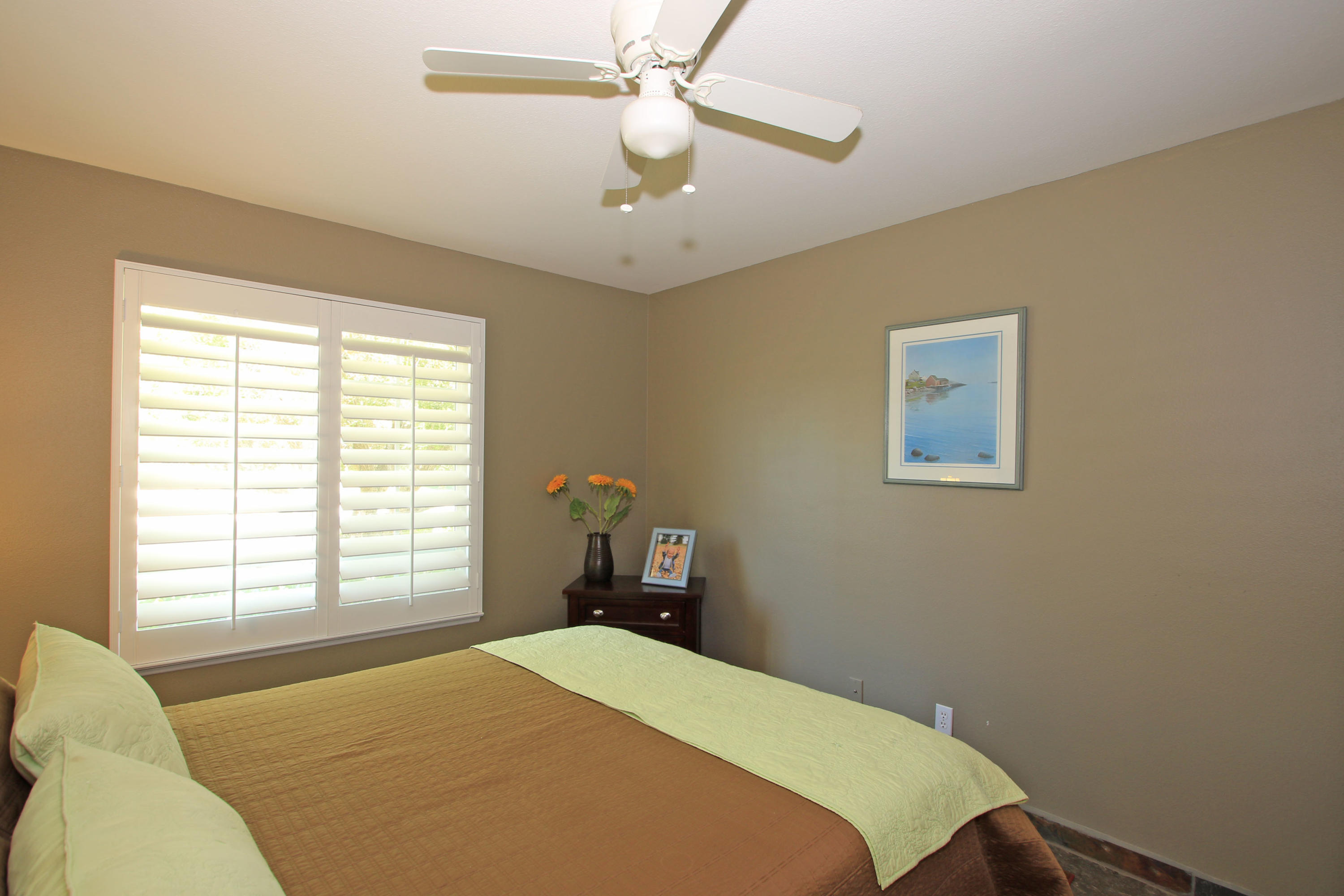 39730 Regency Way Palm Desert, CA 92211 - Photo 30 of 35 a bedroom with a bed and a chandelier