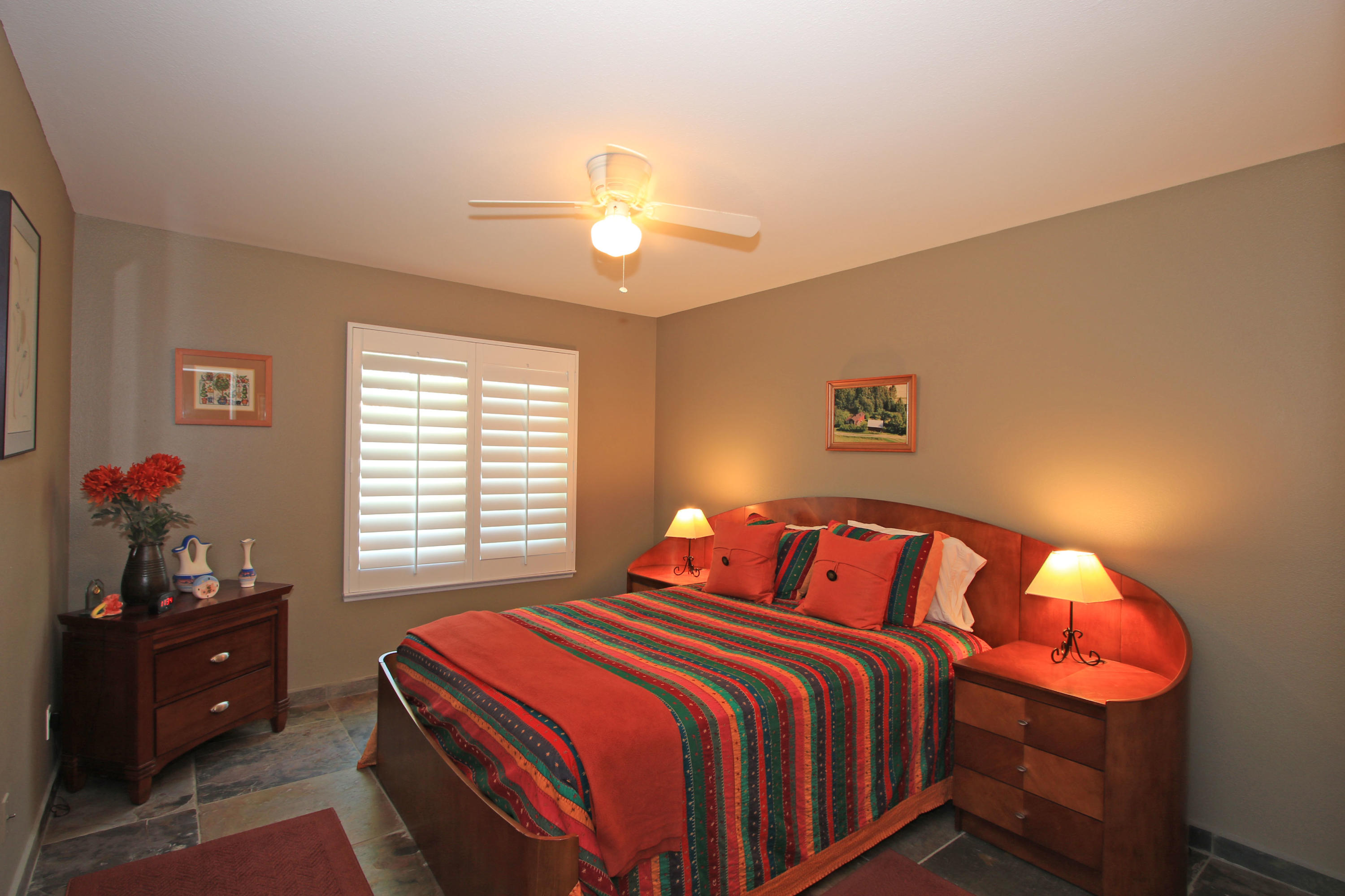 39730 Regency Way Palm Desert, CA 92211 - Photo 31 of 35 a bedroom with a bed and a chandelier