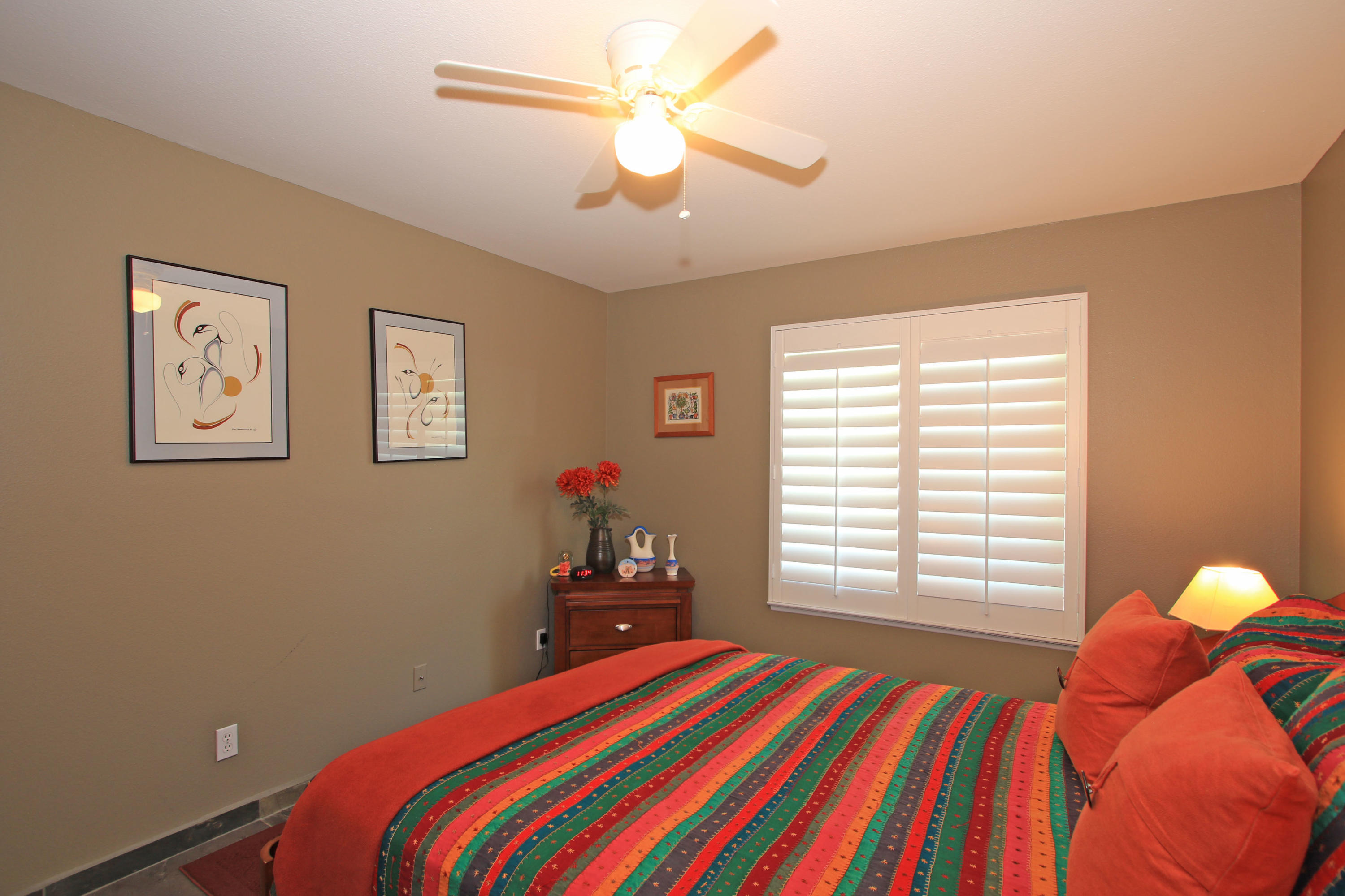 39730 Regency Way Palm Desert, CA 92211 - Photo 32 of 35 a bedroom with a bed and a chandelier