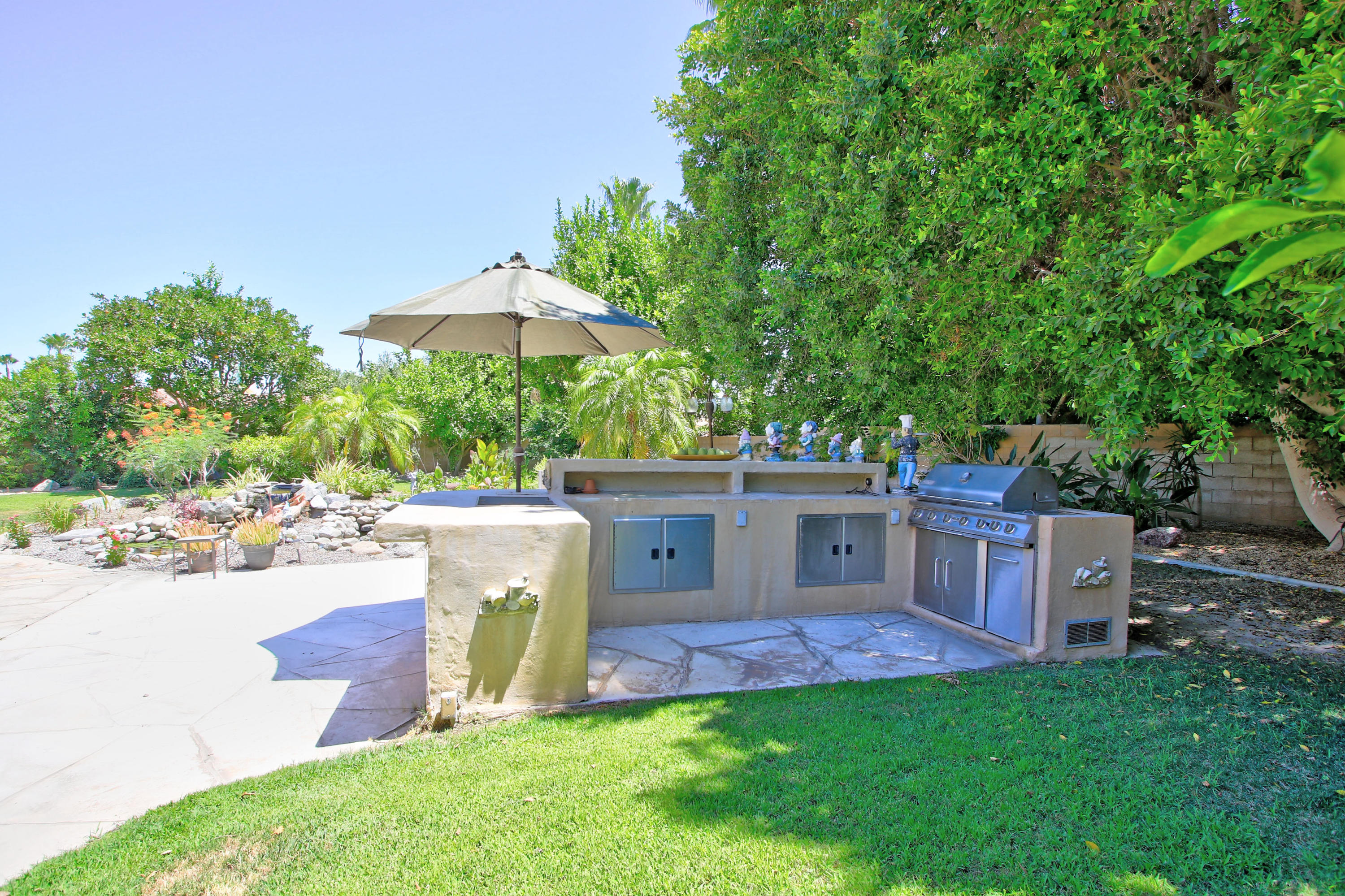 39730 Regency Way Palm Desert, CA 92211 - Photo 7 of 35 a view of a house with a backyard and a patio