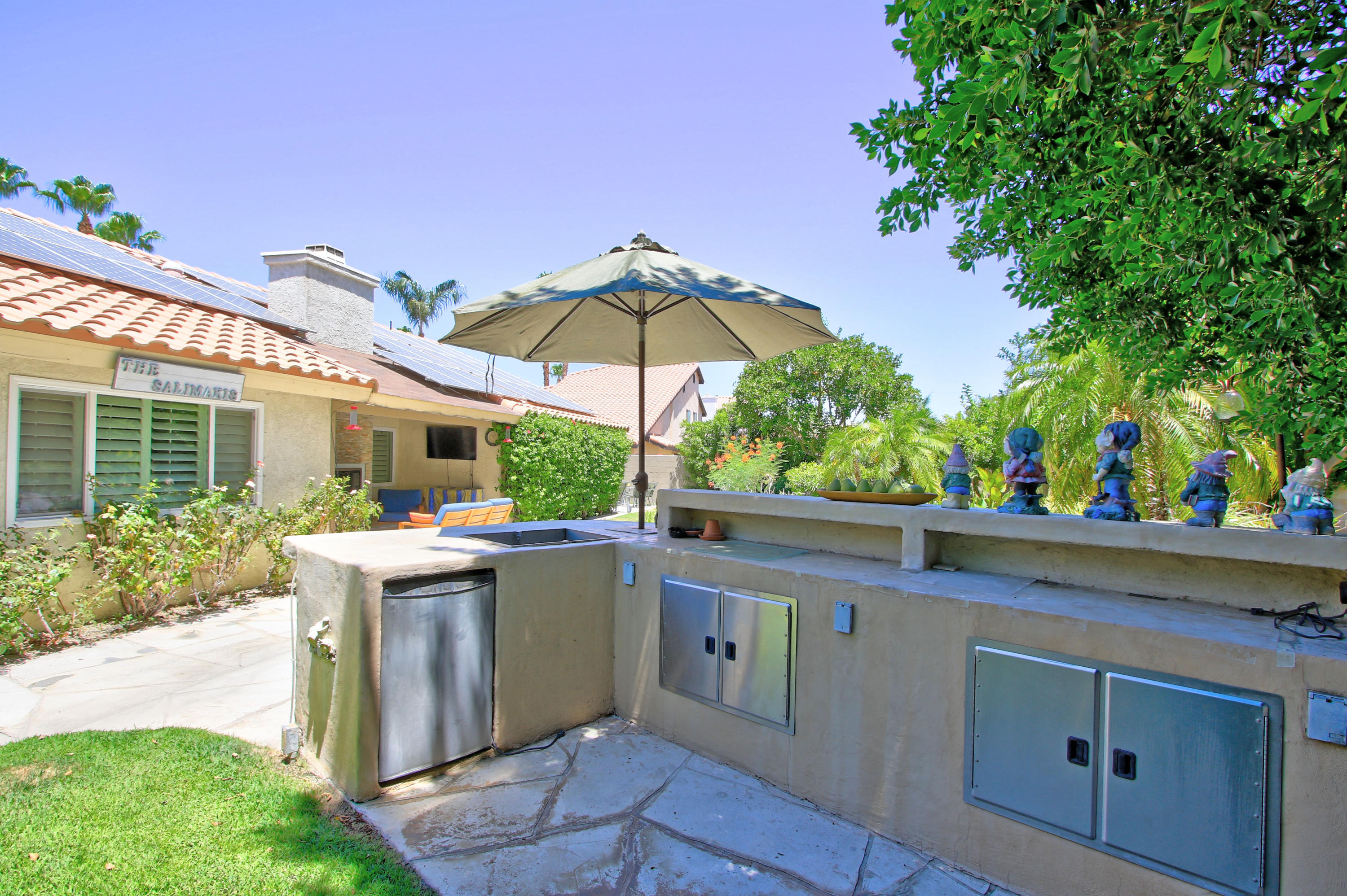 39730 Regency Way Palm Desert, CA 92211 - Photo 8 of 35 a view of a patio with table and chairs under an umbrella