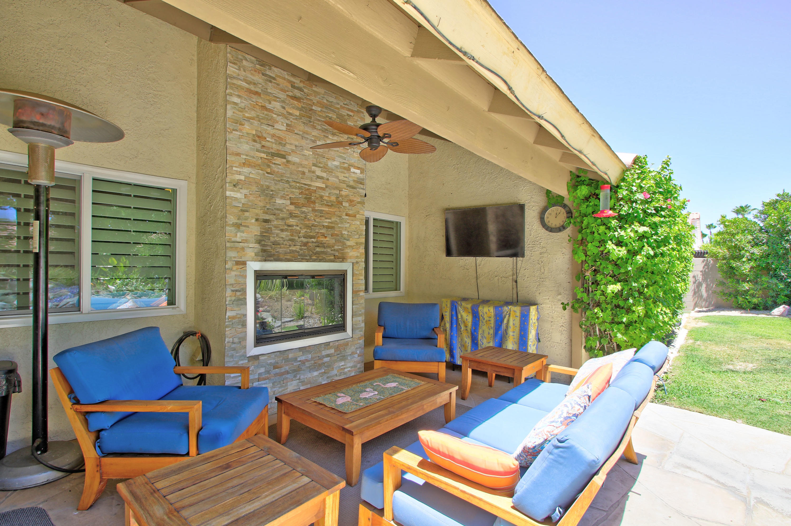 39730 Regency Way Palm Desert, CA 92211 - Photo 9 of 35 a view of a patio with couches table and chairs with wooden floor and fence
