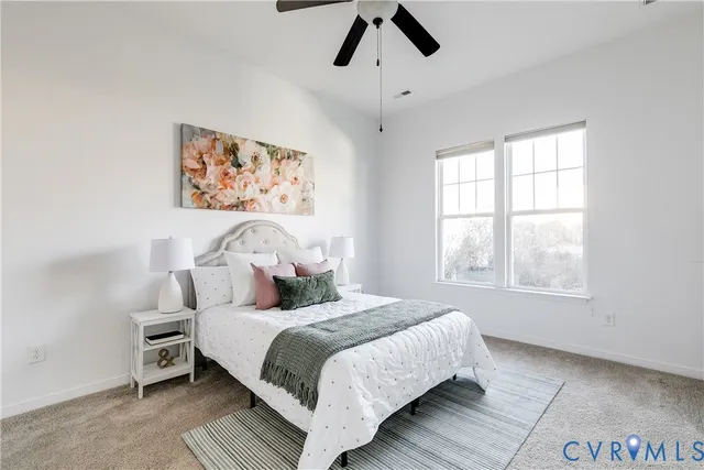 a bedroom with a large bed and a window