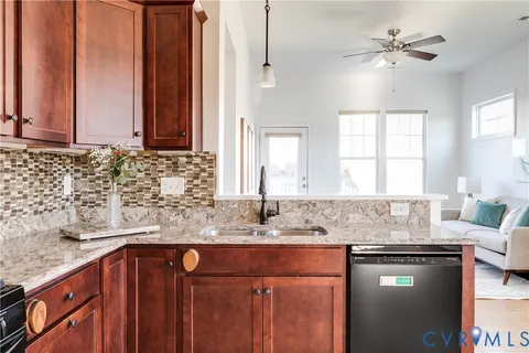 a kitchen with granite countertop a sink and a window