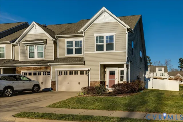 a view of a white house with a yard and garage