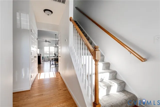 a view of entryway and hall with wooden floor