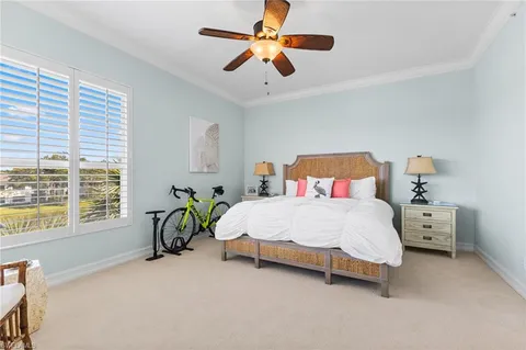 a bedroom with a bed a chandelier and a couch