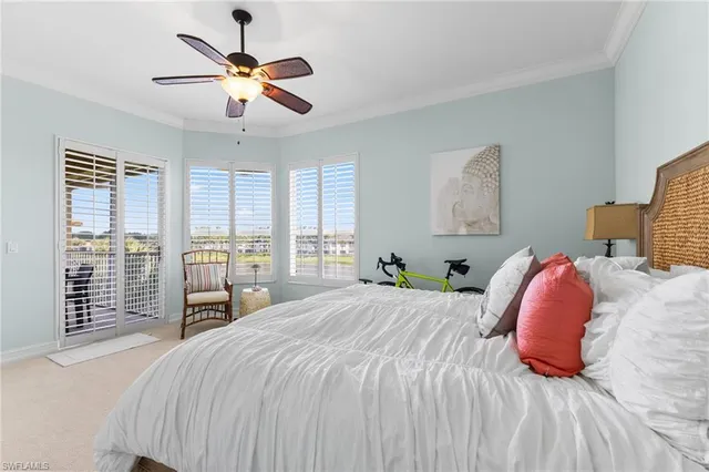 a bedroom with a large bed and a large window