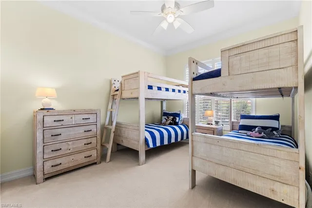 a bedroom with furniture and large windows