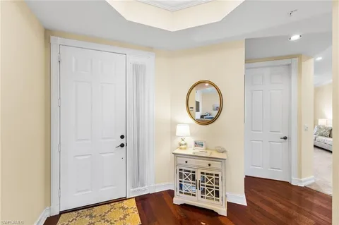 a view of a room with wooden floor cabinet and mirror