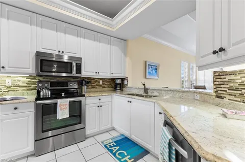 a kitchen with stainless steel appliances granite countertop a sink and stove top oven
