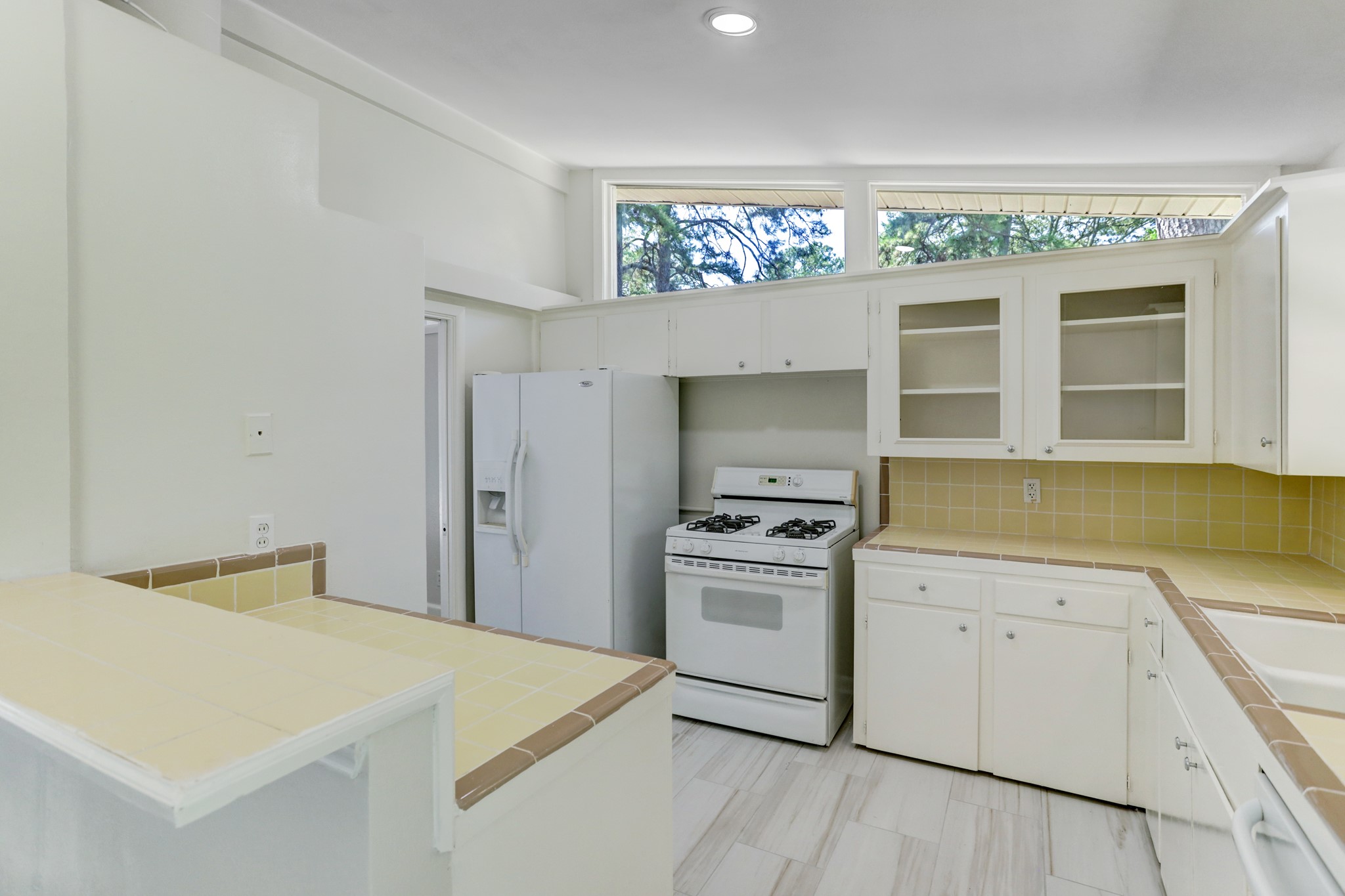 10226 Ivyridge Road Houston, TX 77043 - Photo 11 of 37 Cozy kitchen includes white appliances and a refrigerator