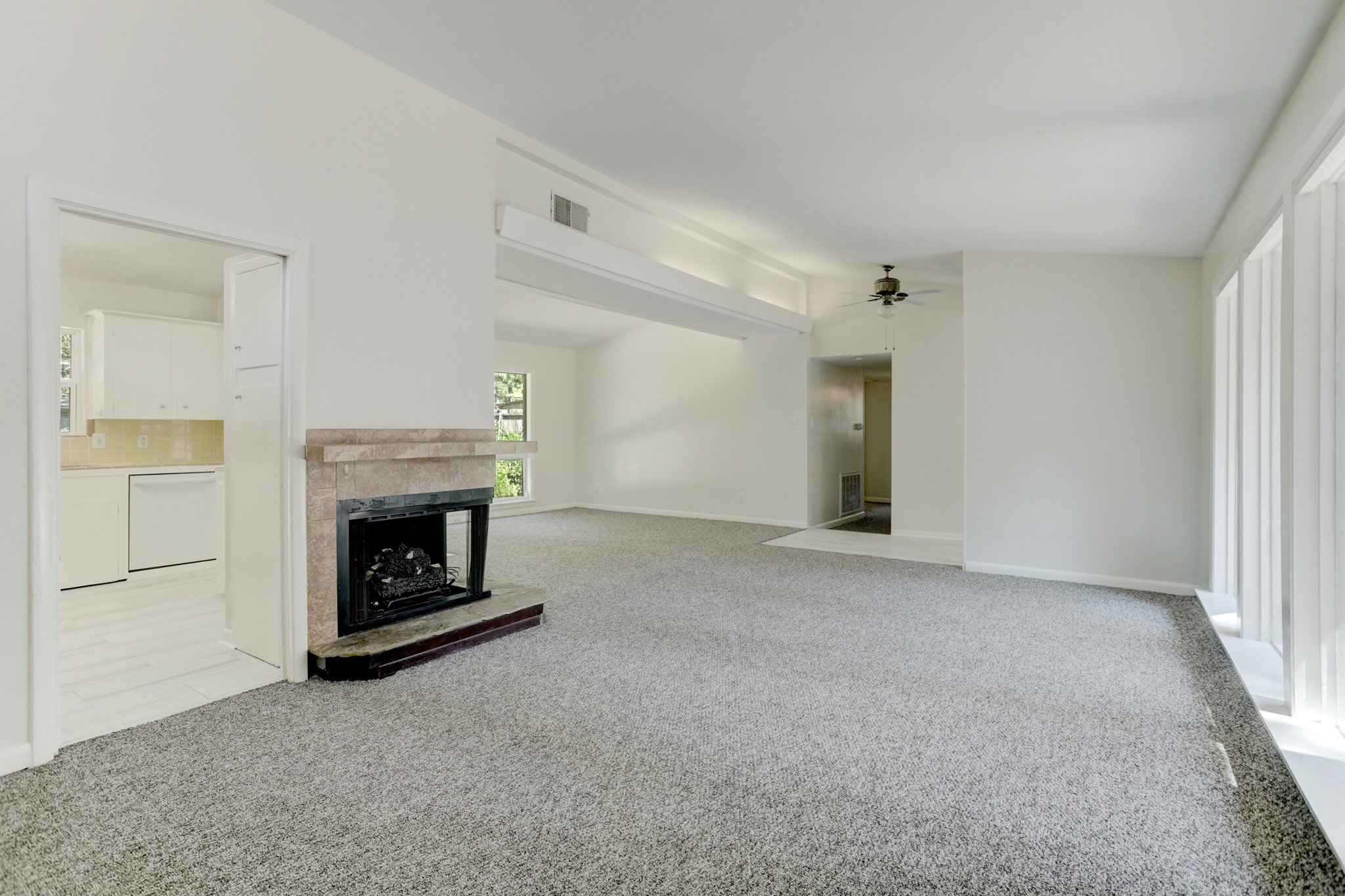 10226 Ivyridge Road Houston, TX 77043 - Photo 9 of 37 The living room is anchored by a wall of windows. Carpet was just recently installed