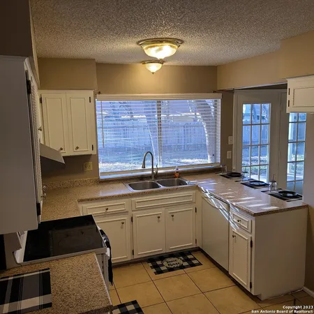 a kitchen with a sink cabinets and window