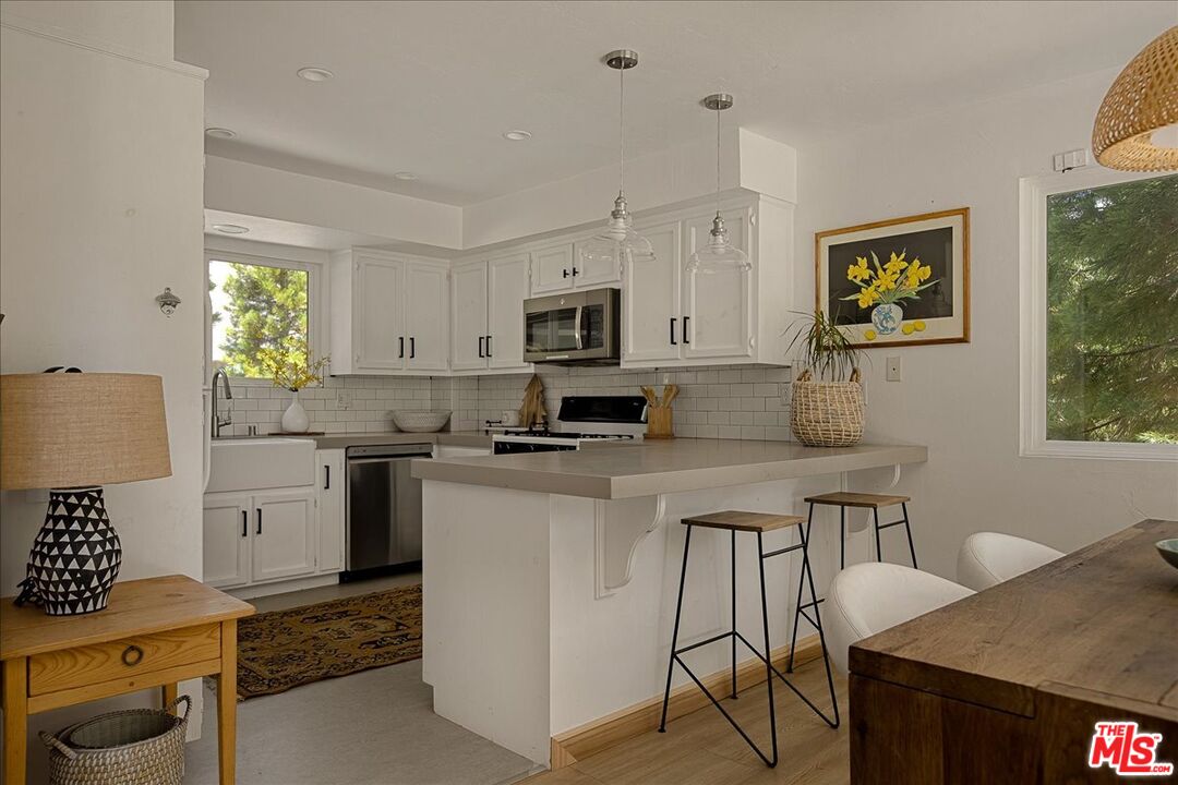 27975 St Bernard Lane Lake Arrowhead, CA 92352 - Photo 13 of 45 a kitchen with a stove cabinets and a refrigerator