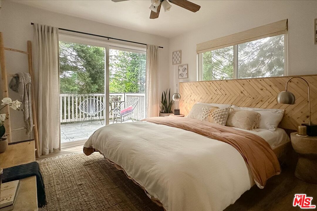 27975 St Bernard Lane Lake Arrowhead, CA 92352 - Photo 18 of 45 a bedroom with a bed and wooden floor