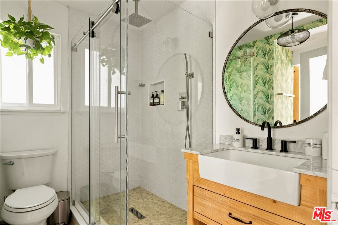 27975 St Bernard Lane Lake Arrowhead, CA 92352 - Photo 23 of 45 a bathroom with a sink a mirror a vanity and shower
